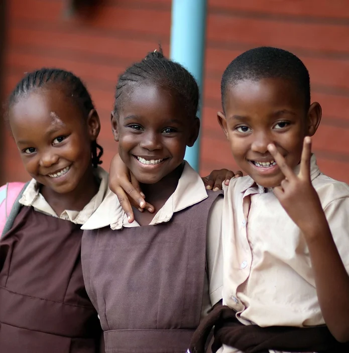 Three students smiling at school